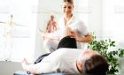 Modern rehabilitation physiotherapy woman worker with client