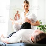 Modern rehabilitation physiotherapy woman worker with client