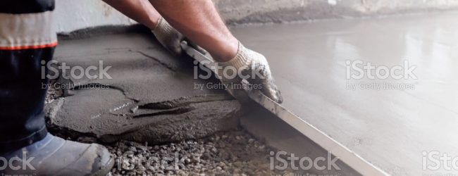 Worker levels a floor cement mortar. Equal floor. Repair of the house.